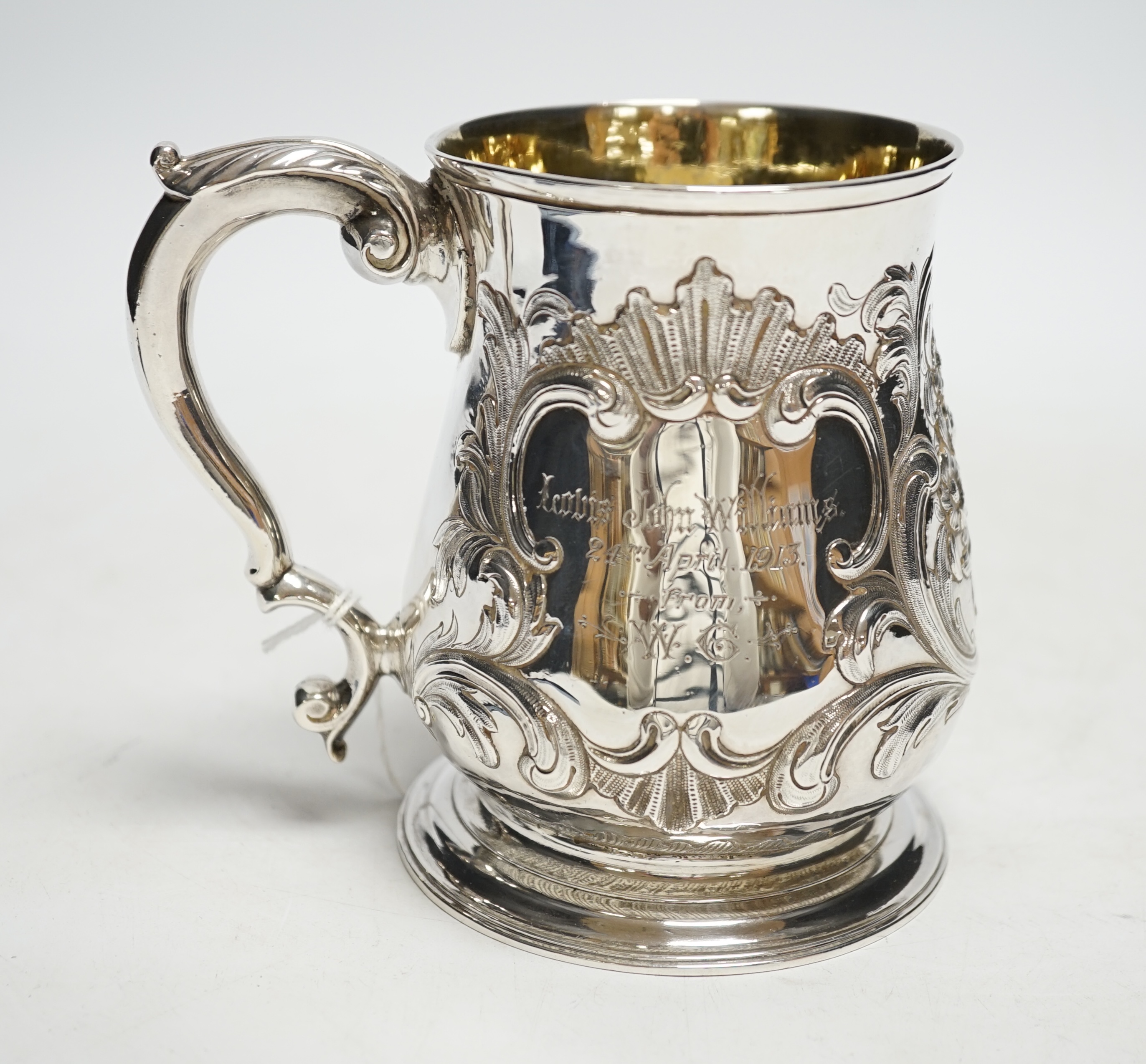 A George II silver pint mug, by John Broughton?, London, 1746, with later embossed decoration and later engraved inscription, 11.8cm, 10.7oz.